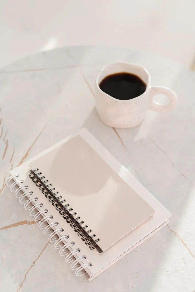 notebook and coffee on desk representing content production using PLR articles