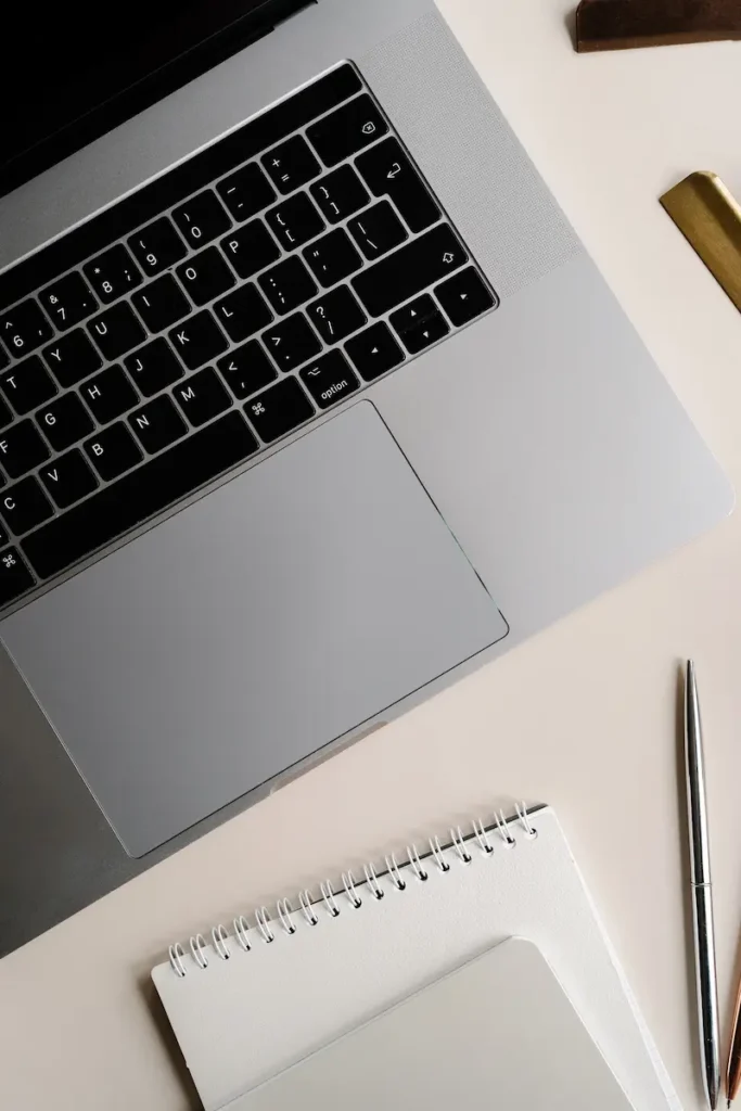 laptop and notebook on desk representing structured blog setup for SEO