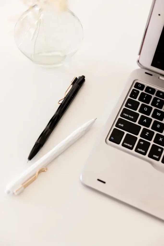 evaluating a website before buying using laptop and notes