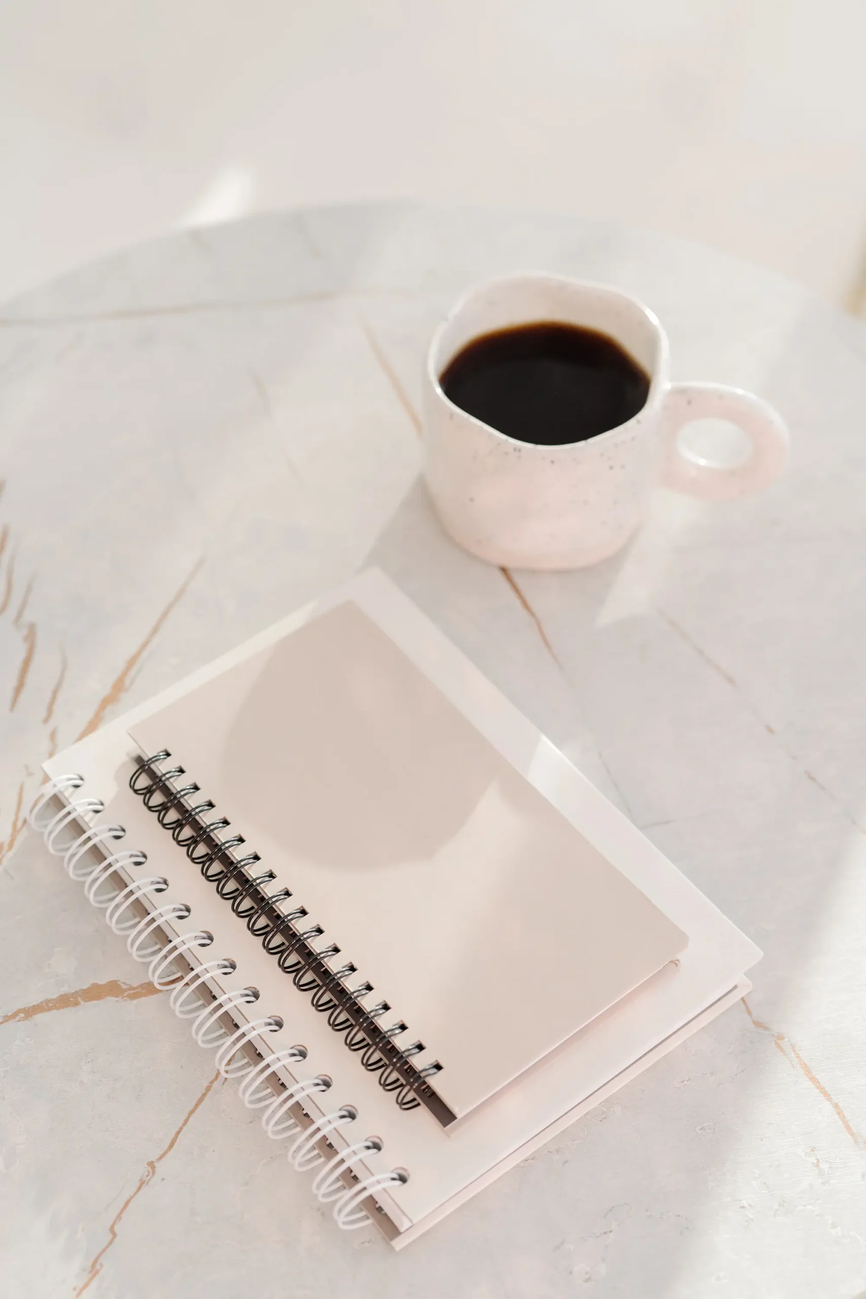 notebook and coffee on desk representing content production using PLR articles