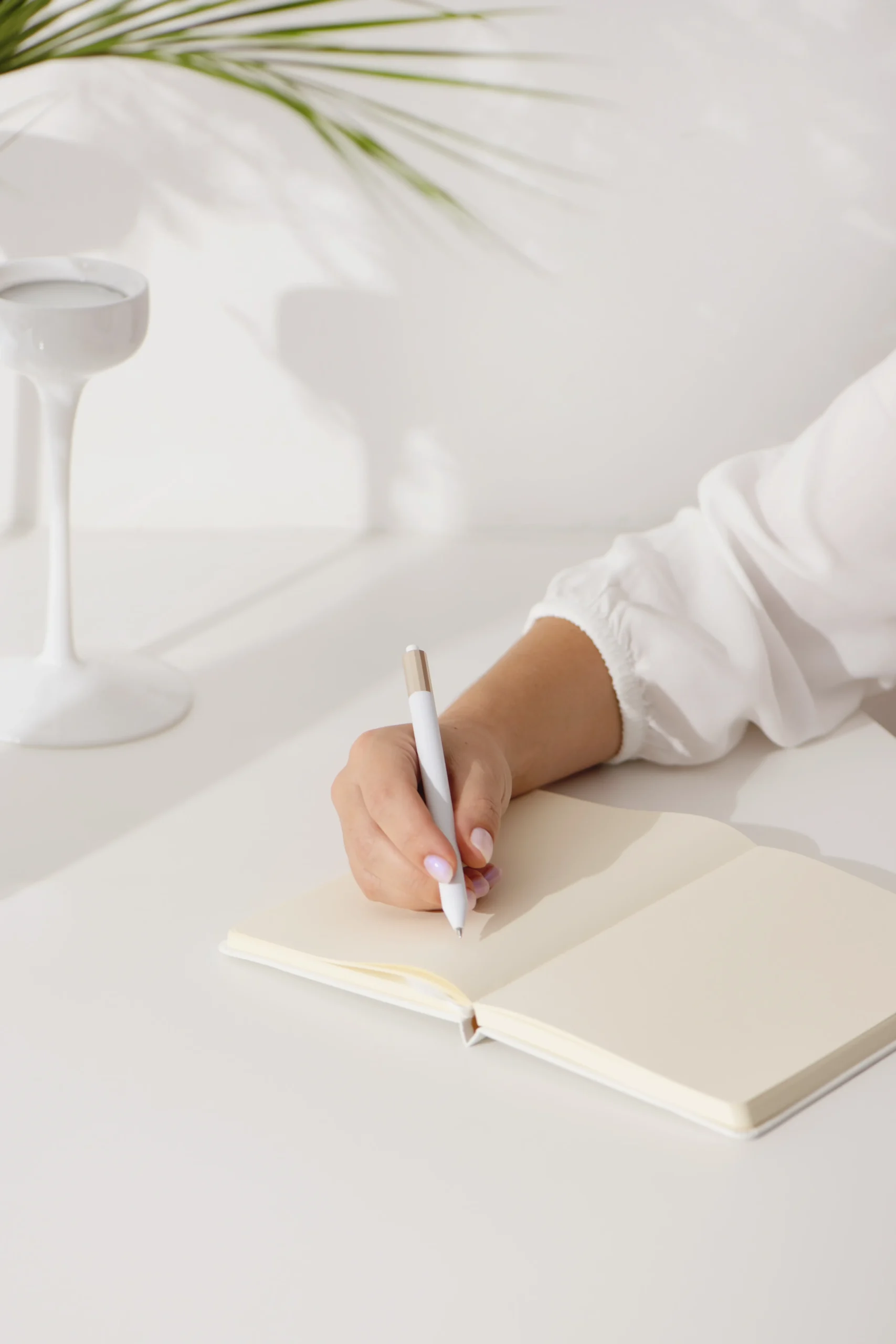 person writing in a notebook at a clean desk representing a clear starting point