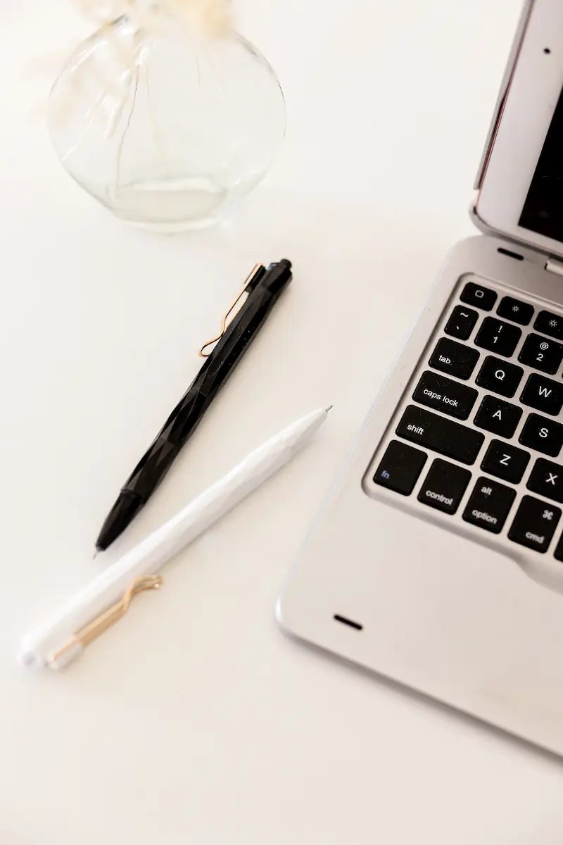 evaluating a website before buying using laptop and notes